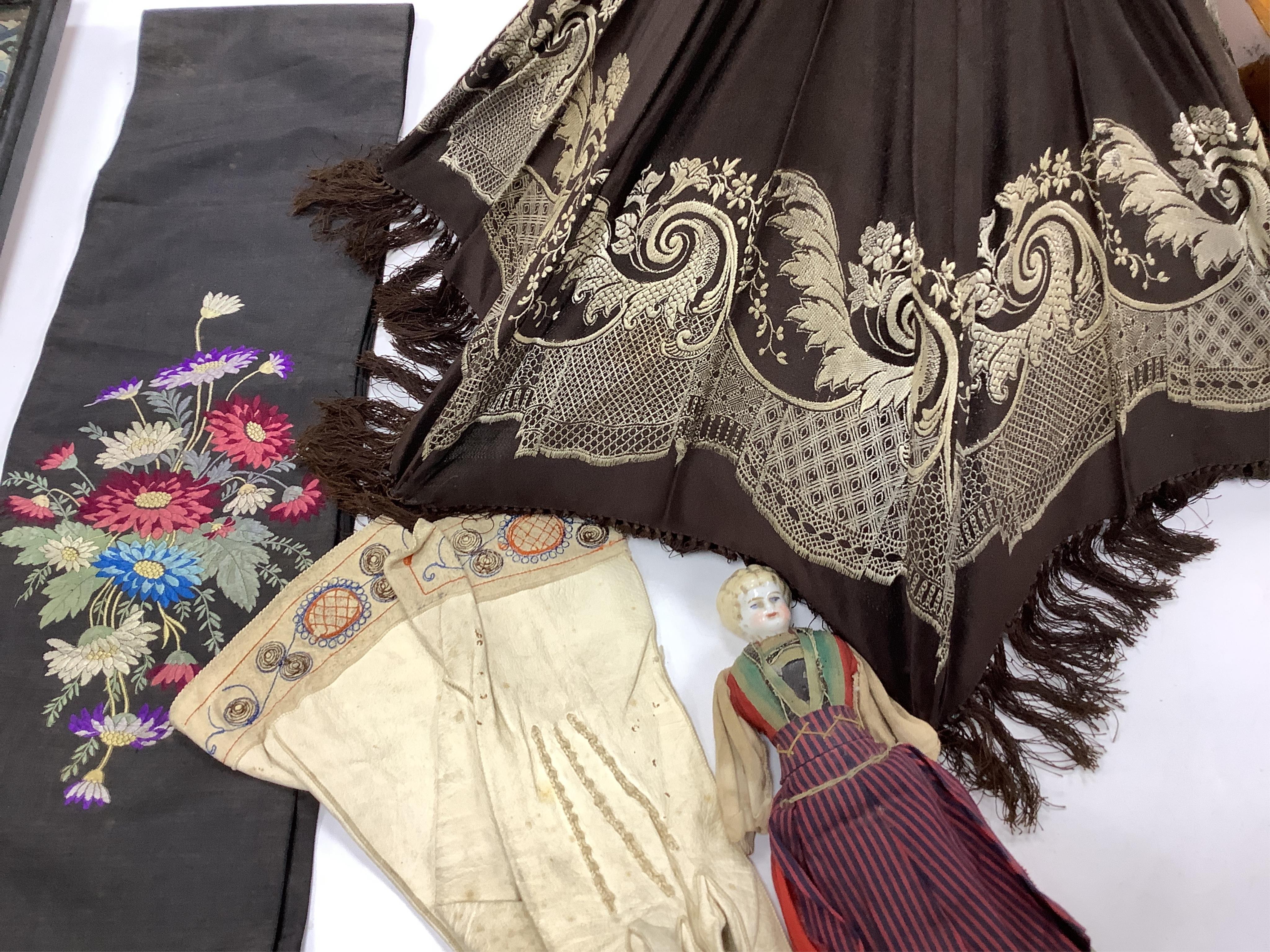 A collection of 19th century lace making patterns, a pair of 19th century kid leather and embroidered gloves, a small china doll in costume and an embroidered sash/ribbon - 210cm long, together with a silk woven lace pat
